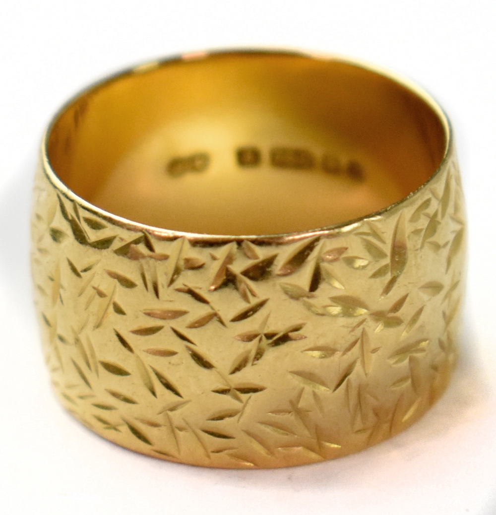 A vintage 1970s 18ct yellow gold wide band ring with all-over textured pattern, size O, approx 9.1g.