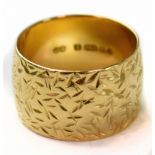 A vintage 1970s 18ct yellow gold wide band ring with all-over textured pattern, size O, approx 9.1g.
