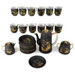 A Japanese coffee service with gilt-heightened decoration against a matte black ground,