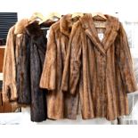 Four vintage c1950s mink coats and jackets comprising a brown mink jacket with roll collar,