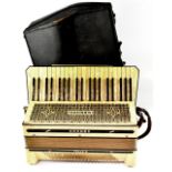 A cased Hohner Tango III piano accordion.
