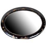 A late 19th/early 20th century oval bevel-edged mirror in black lacquered and highlighted gilt