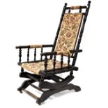 An American rocking chair upholstered in floral fabric.