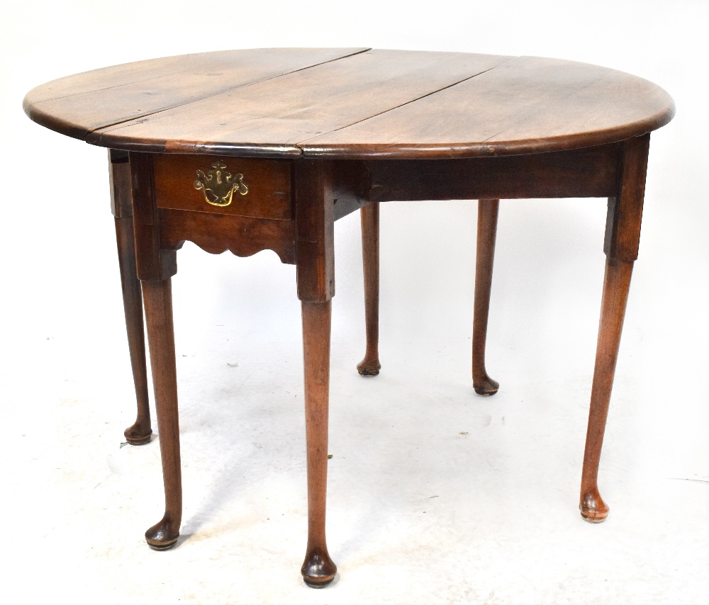 A George II walnut drop-leaf supper table with oval top, with single frieze drawer,