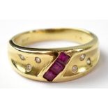 A modern 14ct gold ring, set with a line of three square rubies and six small diamonds, size P,