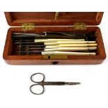 An early 20th century mahogany-cased surgeons kit to include various nail files, scissors, tweezers,