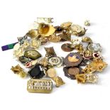 A quantity of military and other badges, medals, etc.