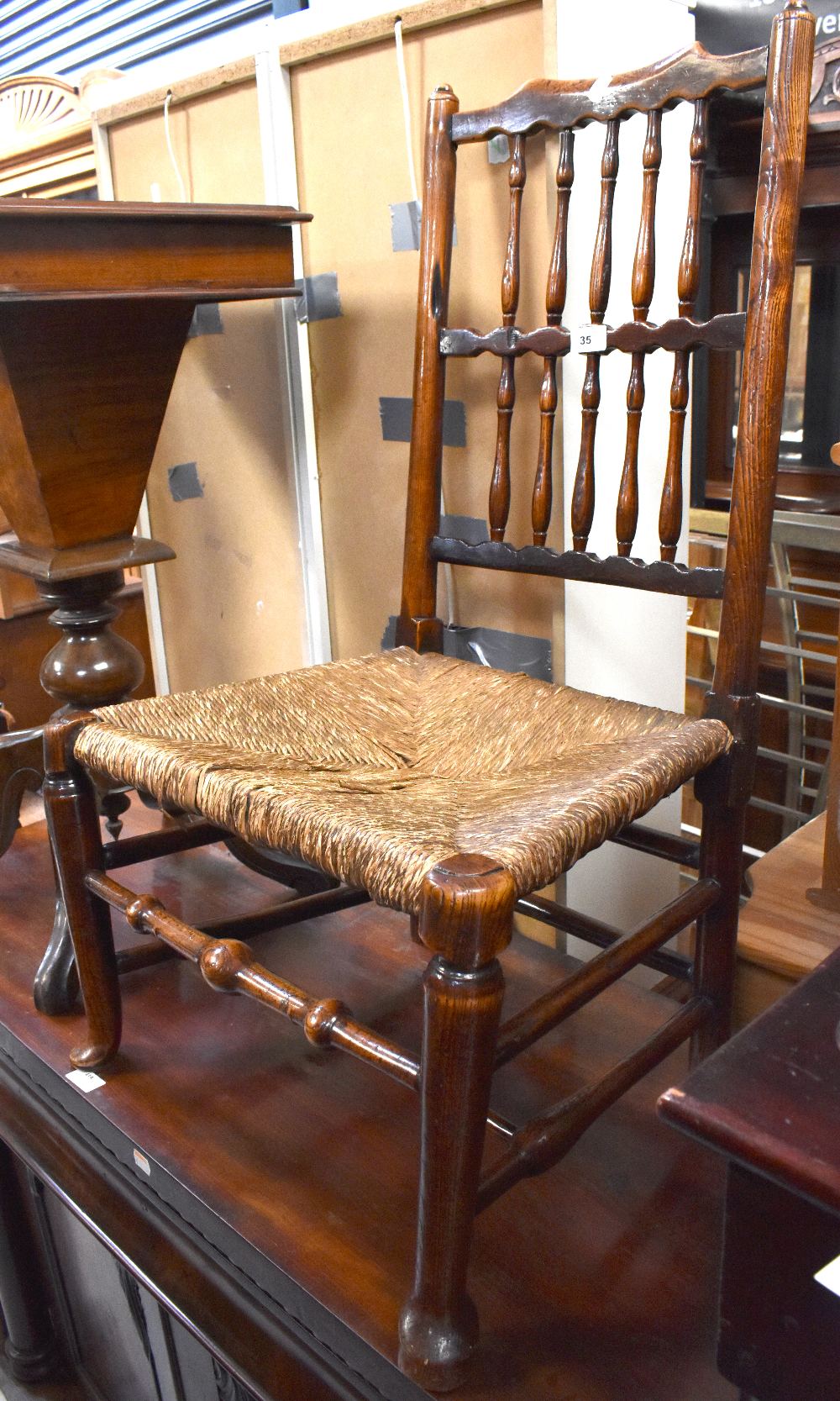 An 18th century rush seated nursing chair, the back rest with two rows of spindles, - Image 2 of 2