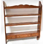 A reproduction mahogany wall-hanging shelf, with three shelves above three small spice drawers,