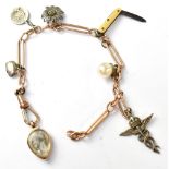 A 15ct gold part watch chain adorned with various charms to include a miniature penknife,