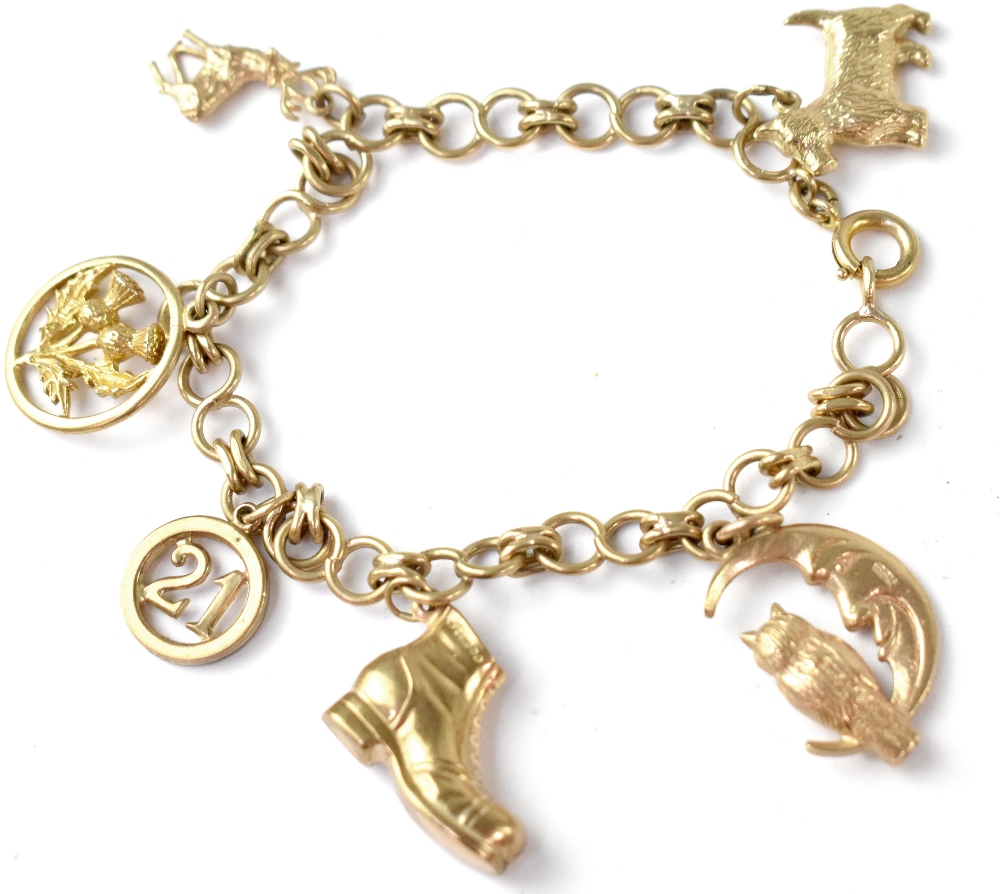 A 9ct gold charm bracelet with six hallmarked 9ct gold charms to include, a boot, a moon and owl,