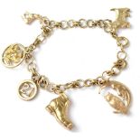 A 9ct gold charm bracelet with six hallmarked 9ct gold charms to include, a boot, a moon and owl,