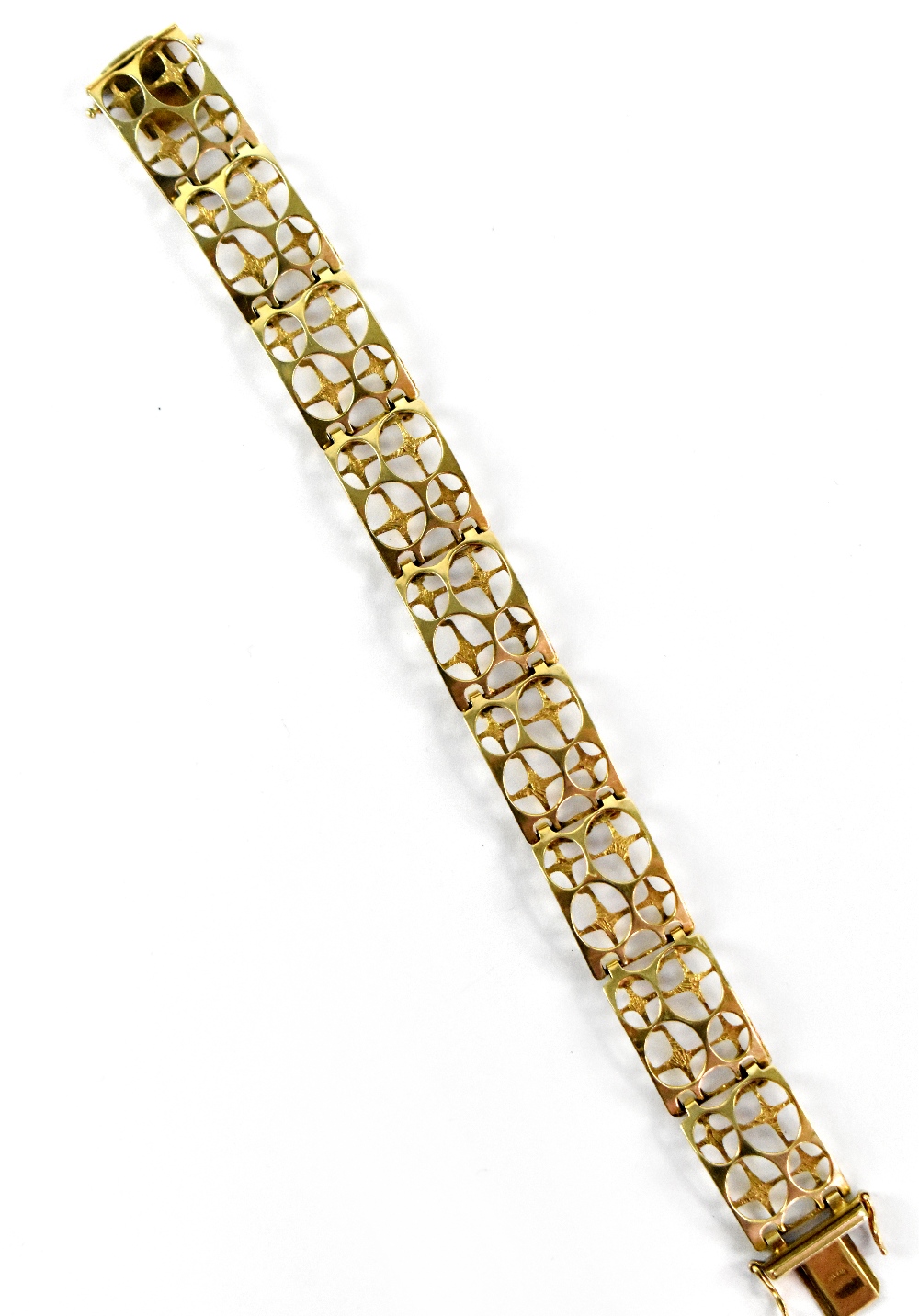 A 9ct yellow gold broad open work bracelet, with twin side safety clasps, length 19.