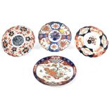 Four late 19th and early 20th century Japanese plates, each painted in a different Imari palette,