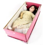 An early 20th century German bisque head doll, with open and close dark brown eyes,