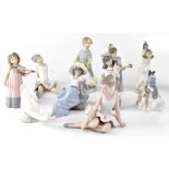 A group of ten Nao figures to include a trio of young girl musicians, two ballet dancers,