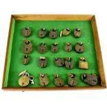 A collection of twenty vintage brass padlocks mounted in a baize-lined frame, 31 x 35cm.