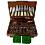 An oak-cased canteen of cutlery containing a nearly complete six place setting of cutlery,