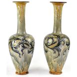 ROYAL DOULTON; a pair of Doulton Lambeth Secessionist baluster vases with long necks,