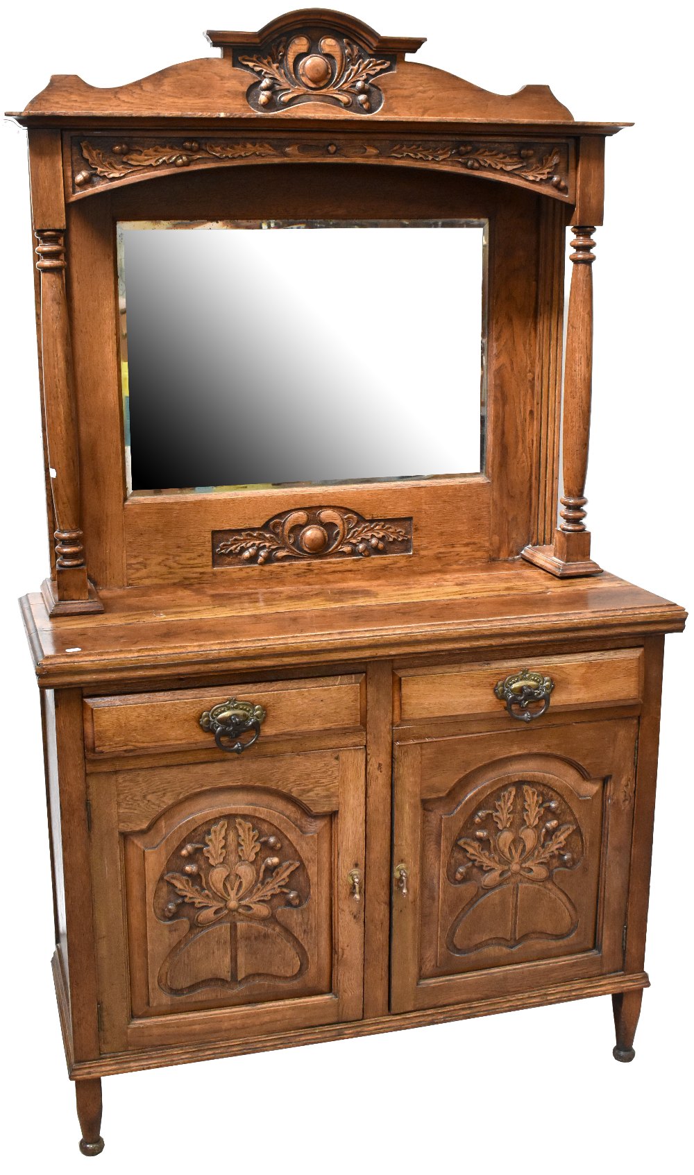 An early 20th century oak Arts and Crafts style dresser,