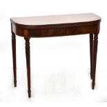 A late 19th/early 20th century mahogany D-end gateleg fold-over tea table to turned tapering legs,