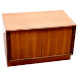 G-Plan; a 1960s retro teak low record cabinet with pair of sliding doors, 49 x 76 x 46cm.