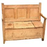 An 18th century rustic pine box seat settle,