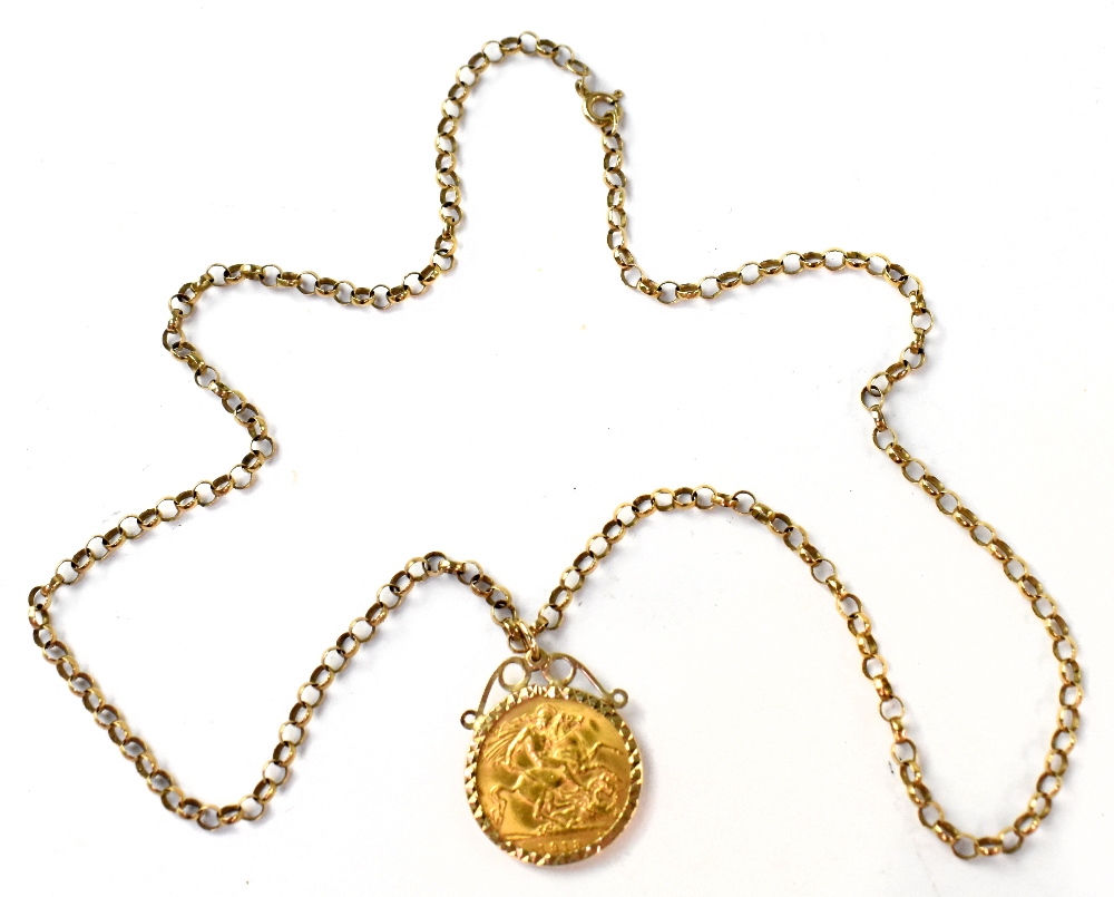 A George V 1913 half gold sovereign in necklace coin mount suspended on a 9ct gold rolo link
