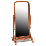 A modern reproduction mahogany framed cheval mirror on scrolling uprights and serpentine outlined