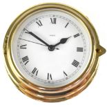 A brass ship's clock, the white dial set with Roman numerals, diameter 11cm.