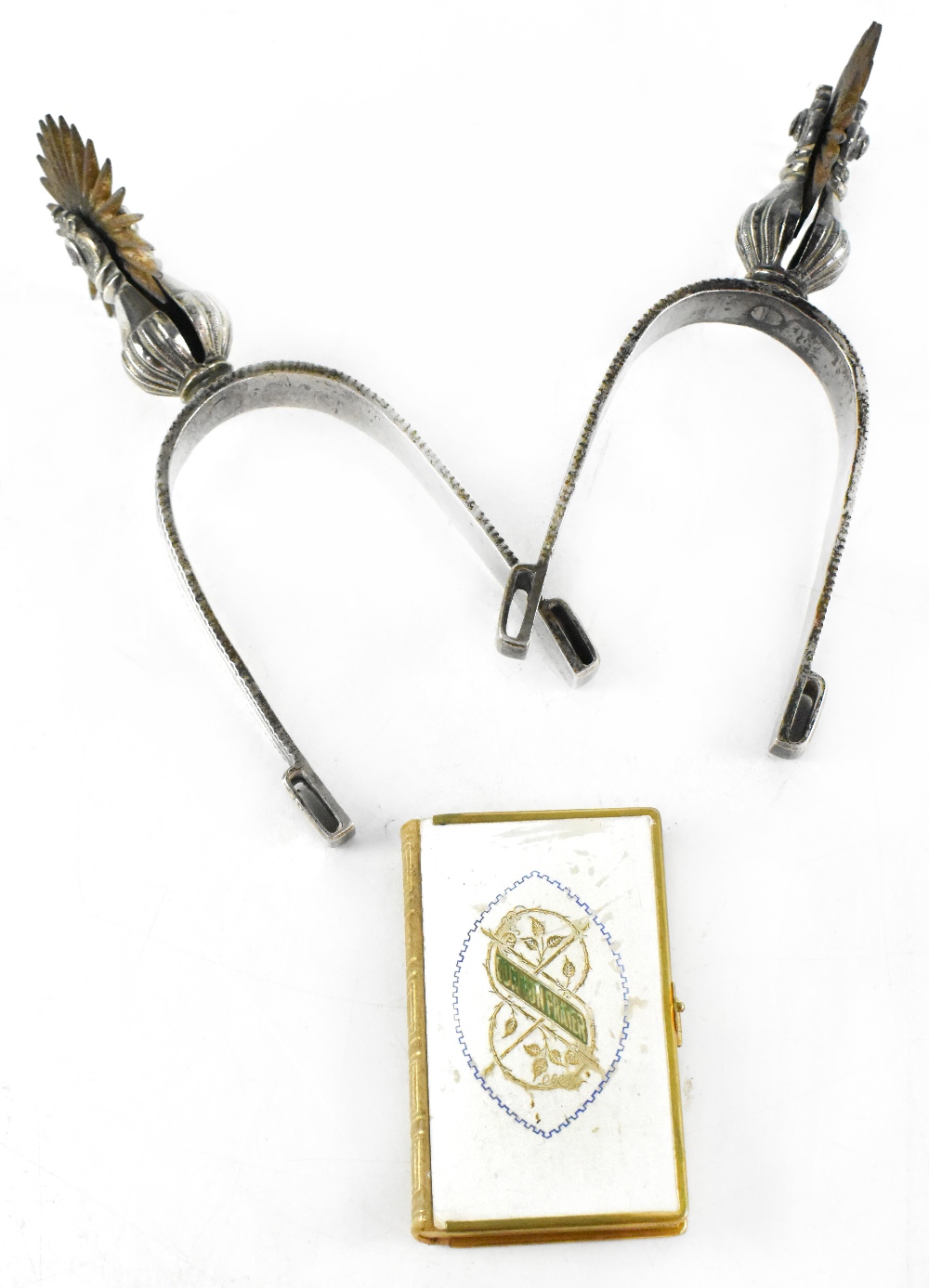 A pair of white metal officer's spurs and a book of 'Common Prayer and Administration of the