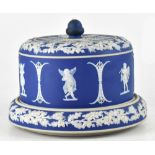 A Wedgwood blue jasper ware cheese dish and cover decorated with putti within oak leaf and acorn