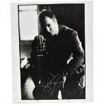 STING; a black and white photograph of the star bearing signature in silver pen.