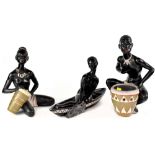 Three early 20th century painted plaster figures depicting African ladies and boy with drum,