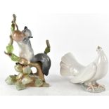 A Lladró figurine of a squirrel on a branch, height 22.5cm, and a Lladró dove (2).