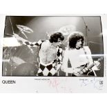 QUEEN; a black and white photograph bearing the signatures of Freddie Mercury and Brian May.