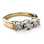 A 9ct gold three stone diamond ring, the three illusion set diamonds in a white metal gallery,