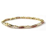 A modern 14ct gold line bracelet set with forty-five square rubies separated by nine groups of