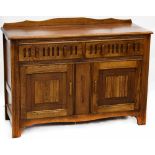 A reproduction oak Priory-style dresser with pair of drawers above pair of panelled doors with