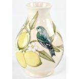 MOORCROFT; a cream ground vase with tube-lined decoration in the 'Finches and Lemons' pattern,