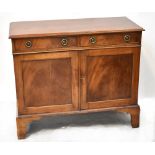 An early 20th century mahogany sideboard with pair of drawers above pair of panelled doors and