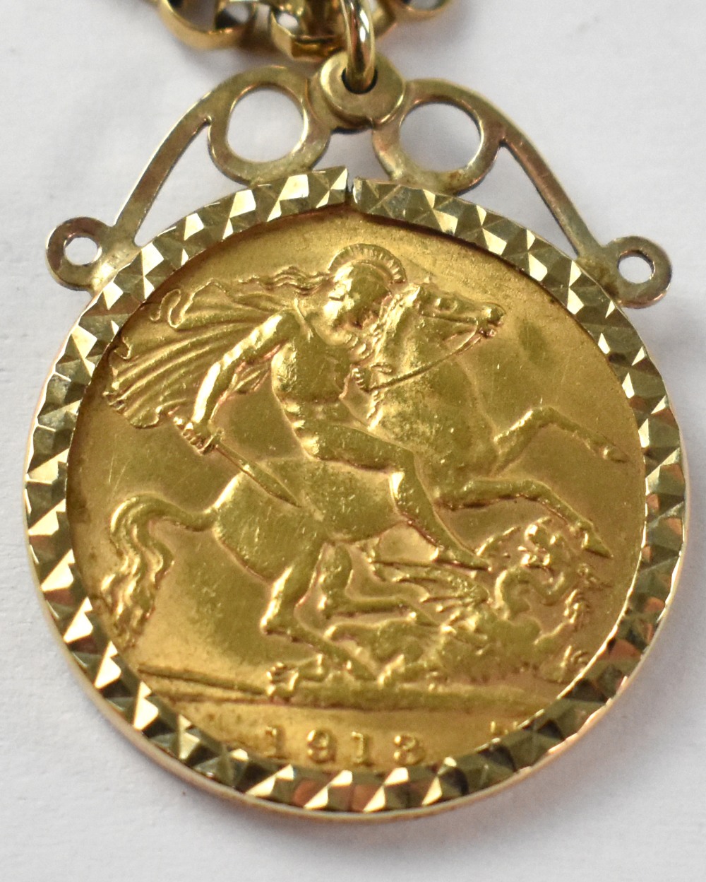 A George V 1913 half gold sovereign in necklace coin mount suspended on a 9ct gold rolo link - Image 2 of 3