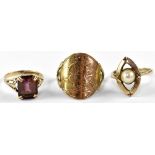 Three 9ct gold rings comprising a ring set with central seed pearl in an open work oval surround,
