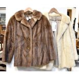 Two vintage c1950s mink jackets comprising a blonde three-quarter length double-breasted mink with