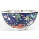 An Oriental bowl, the interior decorated in the Famille Verte palette with foliage, peonies,