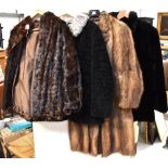 Four c1940s fur coats, a black three-quarter length coat with stand-up collar,