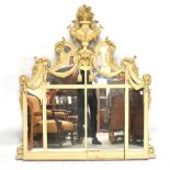 A French carved gilt wood and cream painted overmantel mirror, with elaborate acanthus leaf and