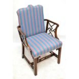 A 19th century mahogany Chippendale style elbow chair, upholstered in a modern striped material with