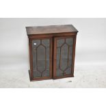 A small late 19th/early 20th century mahogany and inlaid wall hanging display cabinet with twin