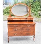 An Edwardian inlaid mahogany mirror back dressing table, the central mirror above an arrangement